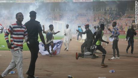 Fans strömen auf das Spielfeld, als Ghana Nigeria zum WM-Platz schlägt