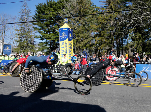 The men’s wheelchair division breaks from the starting line of the 126th Boston Marathon in Hopkinton, Mass.