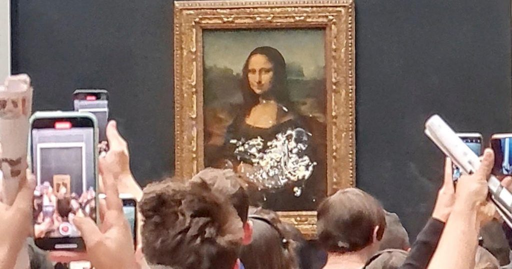 Die Mona Lisa schmiert bei einem scheinbaren Klimaprotest einen Kuchen
