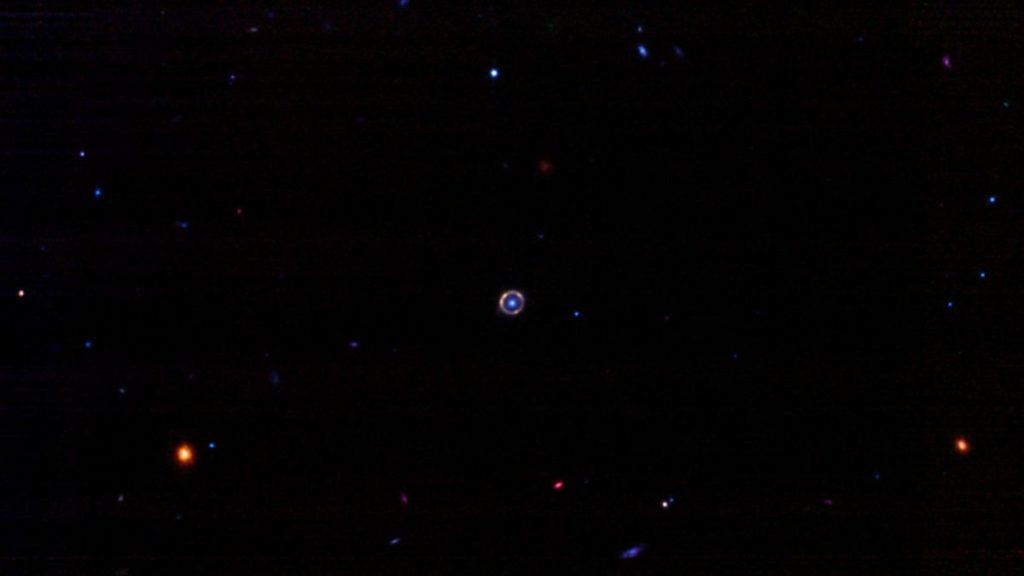 a tiny bright ring against dark space backgrou